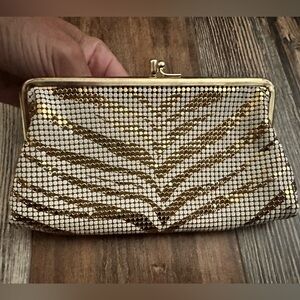 Vintage white and gold clutch inside has a clear lining for two pockets.